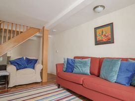 A living room with a sofa and armchair at Saybrook Cottage in Charmouth