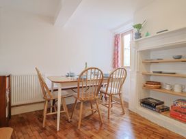A dining room with a table and chairs at Saybrook Cottage in Charmouth