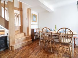 A dining room with a table and chairs at Saybrook Cottage in Charmouth
