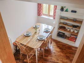 A dining room with a table set for meals at Saybrook Cottage in Charmouth