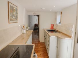 A kitchen with a countertop and sink at Saybrook Cottage in Charmouth