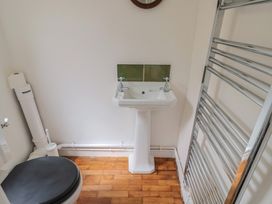 A bathroom with a toilet and sink at Saybrook Cottage in Charmouth