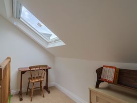 An attic space with a desk and chair at Saybrook Cottage in Charmouth