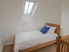 A bedroom with a bed and skylight at Saybrook Cottage in Charmouth