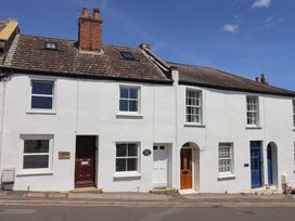 A row of houses with different colored doors at Saybrook Cottage in Charmouth