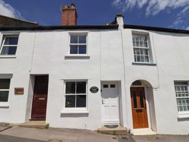 A house with multiple doors and windows at Saybrook Cottage in Charmouth