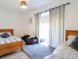 A bedroom with two beds and a bean bag at Tyn Y Weirglodd in Deiniolen