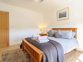 A bedroom with a bed and bedside table at Tyn Y Weirglodd in Deiniolen