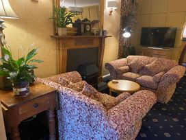 A living room with sofas and a coffee table at Lonsdale House in Bowness-On-Windermere