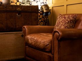 A chair with a cushion in a living room at Lonsdale House Bowness-On-Windermere