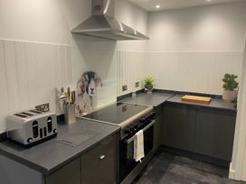 A kitchen with a stove and a toaster at Lonsdale House in Bowness-On-Windermere