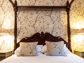 A four-poster bed with pillows in a bedroom at Lonsdale House Bowness-On-Windermere