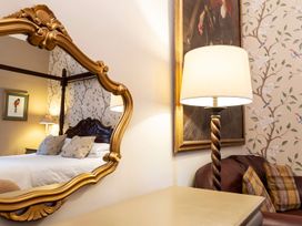 A bedroom with a bed and a lamp at Lonsdale House Bowness-On-Windermere