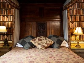 A bedroom with a bed and pillows at Lonsdale House in Bowness-On-Windermere