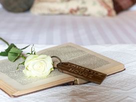 A book with a rose and a keychain at Lonsdale House Bowness-On-Windermere