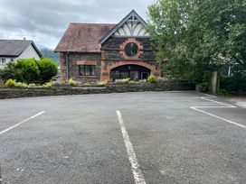 A building with a parking lot and trees at Lonsdale House Bowness-On-Windermere