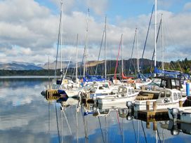 A marina with boats docked at Lonsdale House Bowness-On-Windermere