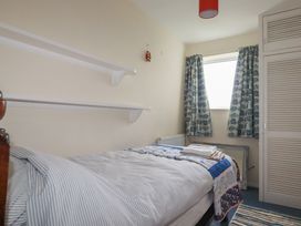 A bedroom with a bed and shelves at 7 Chycoose Parc