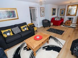 A living room with a sofa and coffee table at Newgale Cottage in Haverfordwest