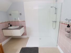 A bathroom with sink and shower at Newgale Cottage Haverfordwest