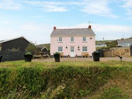 A house with a table and chairs outside at Newgale Cottage in Newgale
