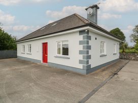 A house with a red door and windows at River House in 