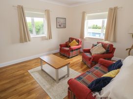 A living room with chairs and a coffee table at River House
