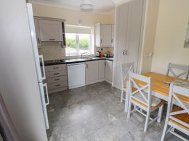 A kitchen with a table and chairs at River House