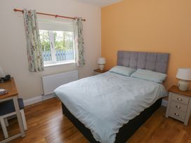 A bedroom with a bed, nightstand and window at River House 