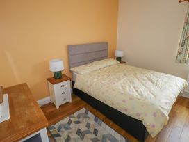 A bedroom with a bed and bedside lamps at River House