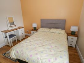 A bedroom with a bed and vanity table at River House