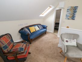A snug with a blue sofa and two chairs at River House