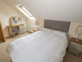 A bedroom with a bed and desk at River House