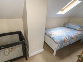 A bedroom with a bed and a crib at River House