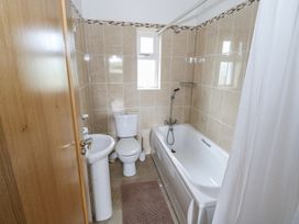 A bathroom with a bathtub, toilet, and sink at River House