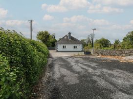 A house with a driveway and hedges at River House