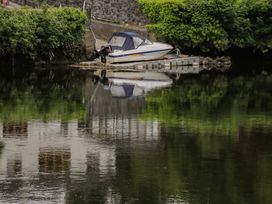 A boat docked on calm water at River House
