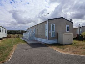 A caravan with steps and a satellite dish at Caravan i35 Towyn