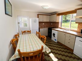 A kitchen with a dining table and chairs at Cahir Cottage in Ballinrobe, County Mayo