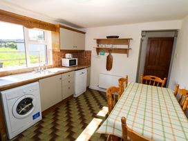 A kitchen with a sink and washing machine at Cahir Cottage Ballinrobe, County Mayo