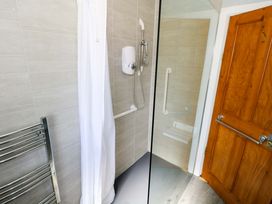 A bathroom with a shower and towel radiator at Cahir Cottage in Ballinrobe, County Mayo