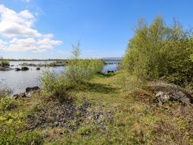 A path beside water and rocks at Cahir Cottage in Ballinrobe, County Mayo