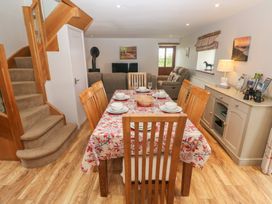 A dining room with table and chairs at The Gallops in Barry