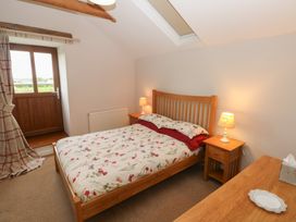 A bedroom with a bed and bedside table at The Gallops in Barry