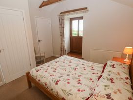 A bedroom with a bed and window at The Gallops in Barry