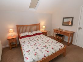 A bedroom with a bed and nightstand at The Gallops in Barry