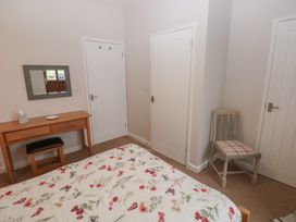A bedroom with a bed and a desk at The Gallops in Barry