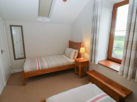 A bedroom with two beds and a window at The Gallops in Barry