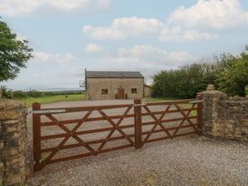 A house with a gravel driveway and gate at The Gallops in Barry