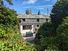 A cottage with a conservatory and patio area at Trehaverock Cottage St. Endellion near Port Isaac